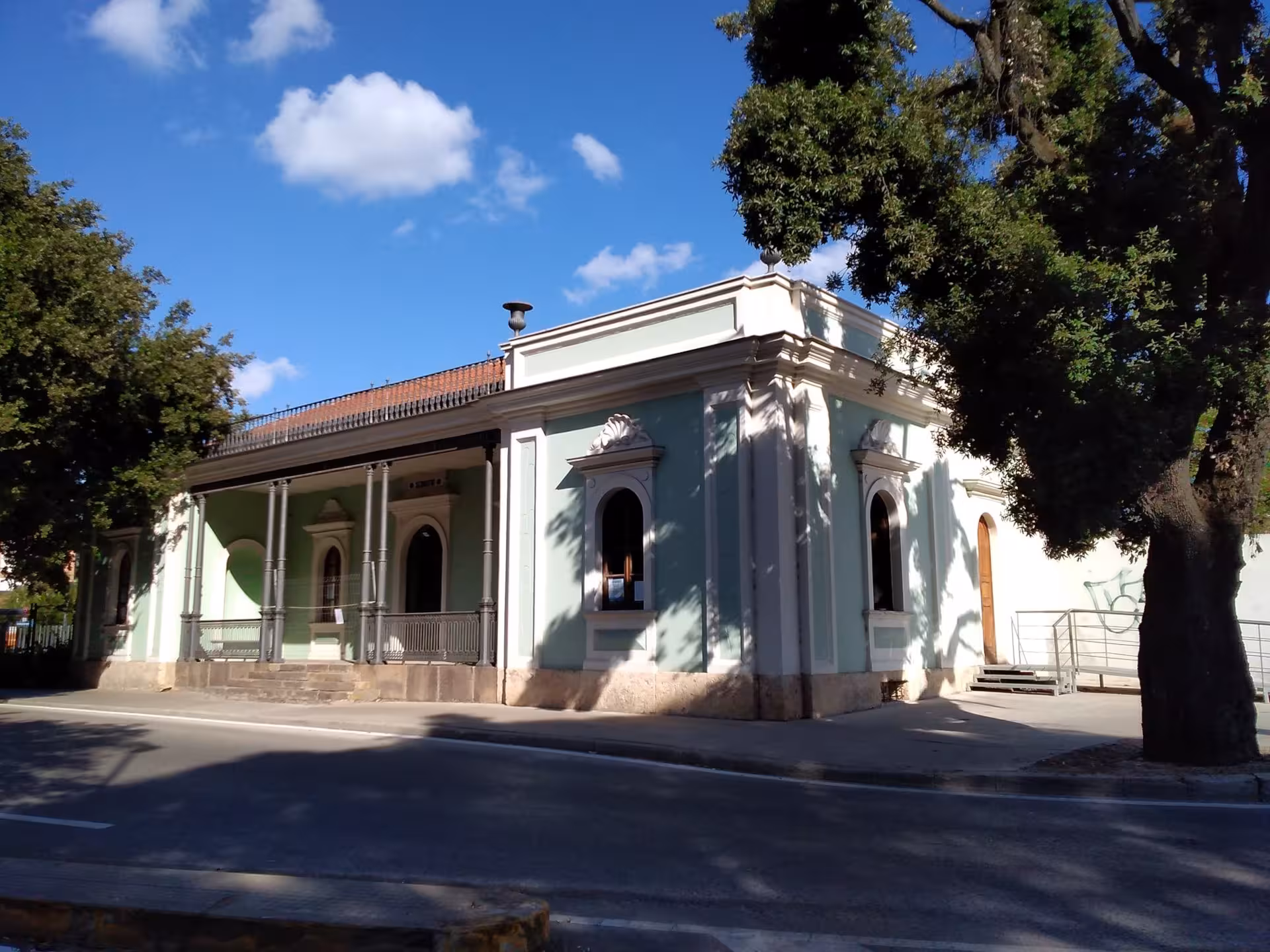 Historic building in Sassari under a clear blue sky, part of the Sea and Water Ecomuseum tour experience.