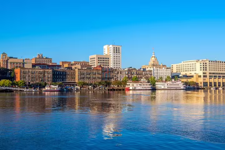Savannah waterfront skyline with riverboats docked along the Savannah River on a sunny day