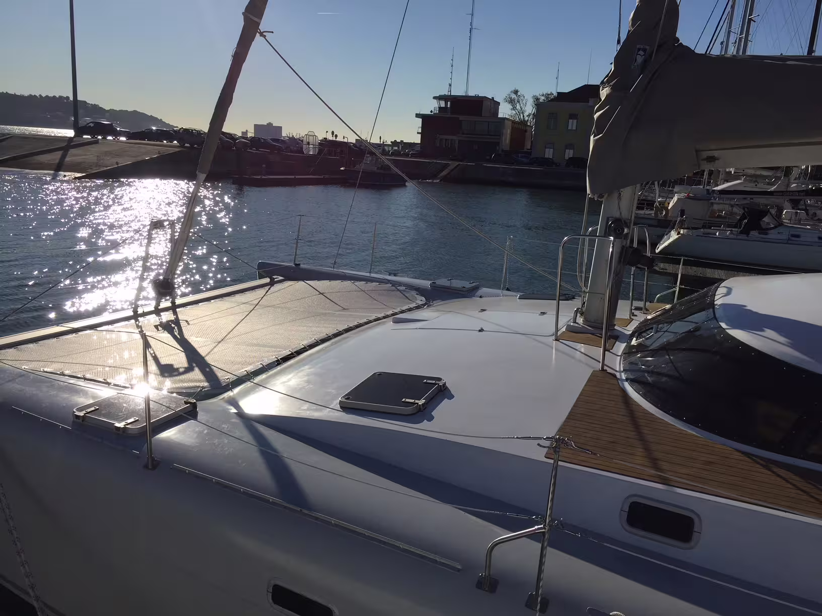 Sailing catamaran 'Scarlett' docked under sunny skies, ready for a private 2-hour tour for up to 16 people.