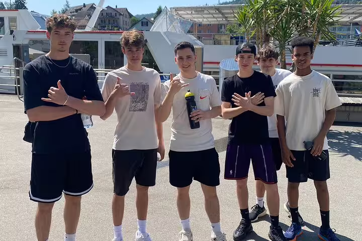 Teens at Schaffhausen riverside dock starting a self-guided scavenger hunt and sightseeing walking tour in Switzerland