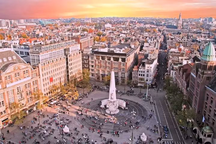 Aerial view of Amsterdam Dam Square at sunset, ideal for Schiphol Airport to Amsterdam private transfer