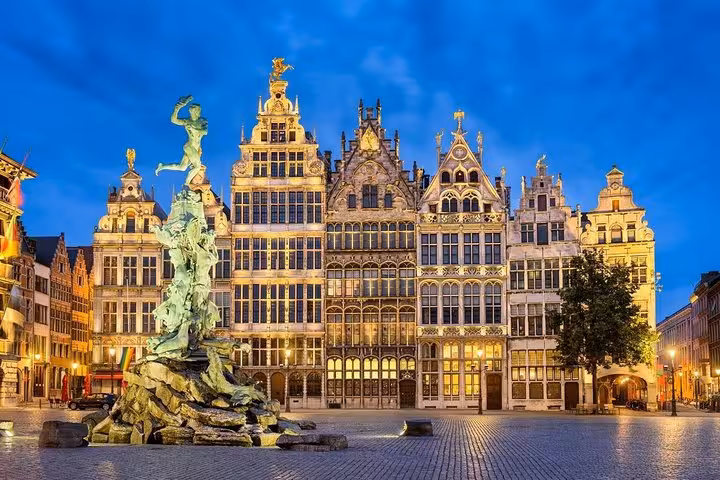 Antwerp Grote Markt guild houses at dusk, destination for Schiphol Airport private transfer to Antwerp