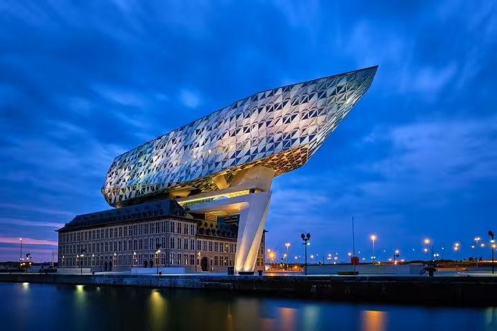 Antwerp Port House at dusk on the Scheldt, scenic highlight on a Schiphol Airport private transfer to Antwerp