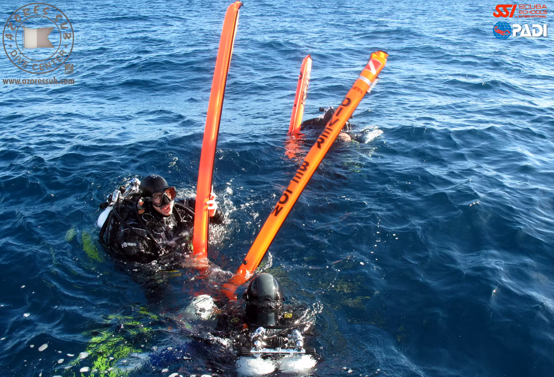 Scuba divers surface with orange SMB marker buoys during Deep Diver tour in São Miguel, Azores Atlantic