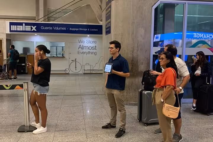 Travelers waiting at SDU Airport for private transport to Rio de Janeiro hotels, showcasing convenient transfer services.