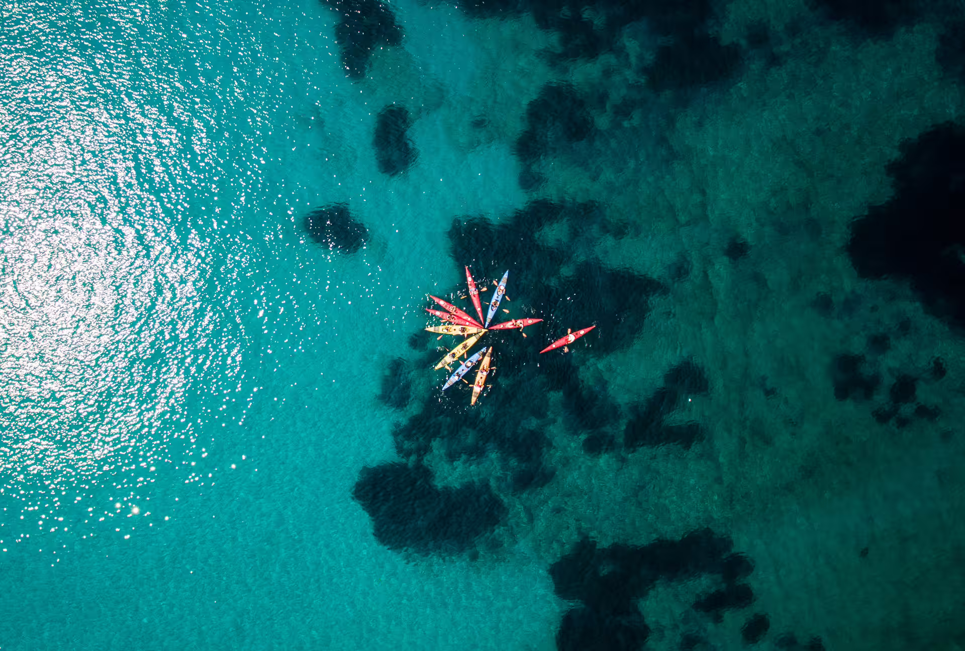 Aerial view of sea kayaks on turquoise water near Kardamyli and Stoupa, Messinia, Peloponnese coast