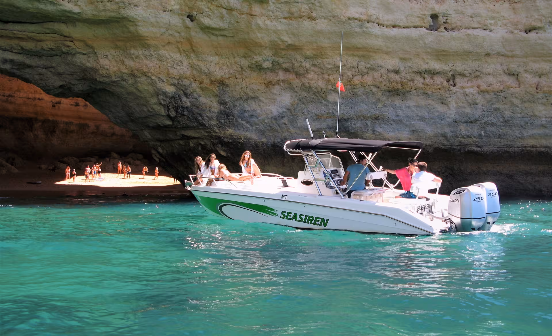 Seasiren Private Tour 2H speedboat cruising crystal-clear Algarve waters past Benagil Cave and its golden sand beach
