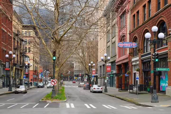 Historic brick buildings and tree-lined street in Seattle's Pioneer Square during Klondike Gold Rush walking tour