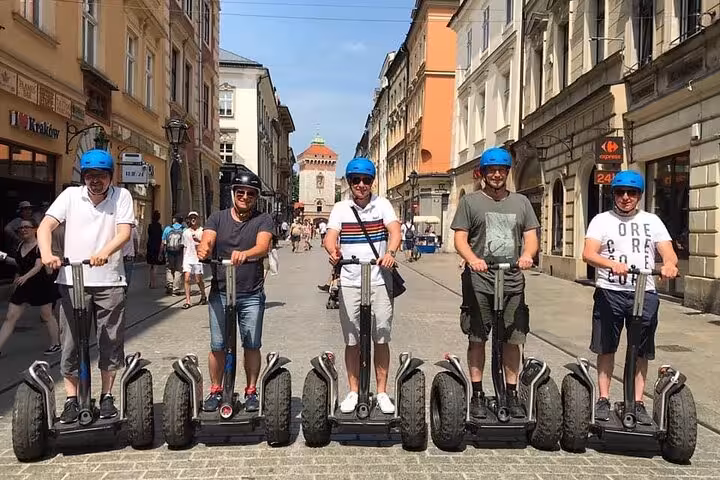 Group of tourists on Segways in Krakow's Jewish Quarter, experiencing the city's historic streets and vibrant atmosphere.