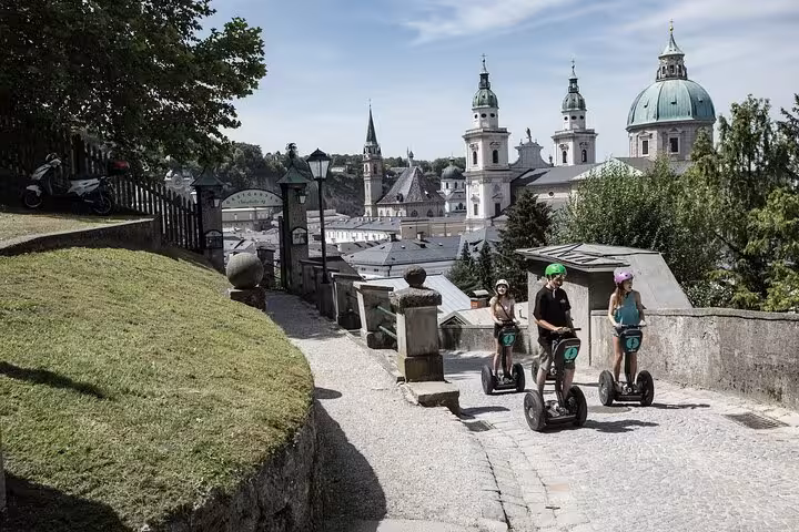 A group on Segways tours Salzburg's historic streets with stunning views of the city's famous domes and spires.