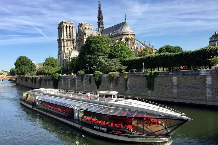 Bateaux Mouches cruise boat on the Seine River with Notre-Dame Cathedral in background, Paris