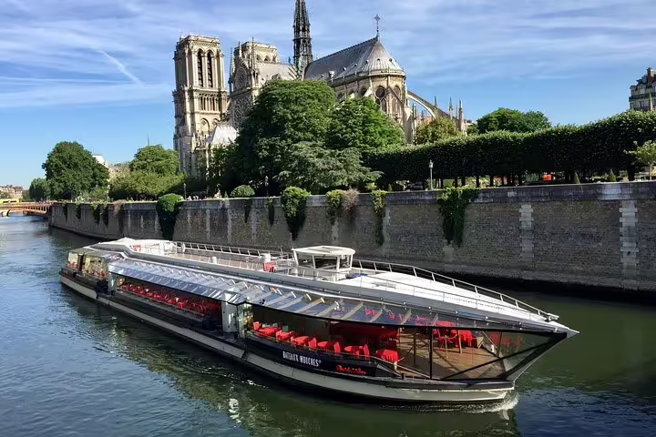 Bateaux Mouches lunch cruise boat on the Seine River with Notre-Dame Cathedral in background, Paris