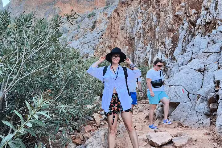 Hikers exploring rocky trails at Seitan Limania, featuring scenic views and lush greenery, ideal for adventurous beach tours.