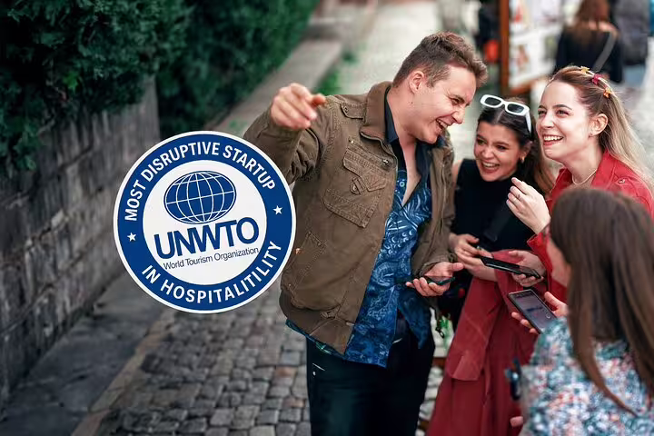 Group of tourists laughing and exploring city streets with smartphones, UNWTO Most Disruptive Startup in Hospitality badge