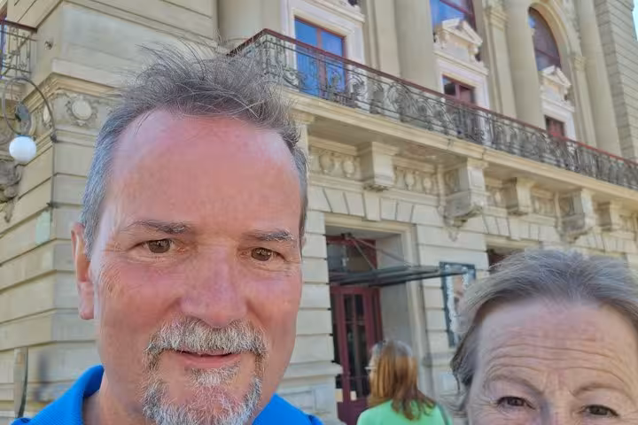 Couple taking selfie in front of historic building in Porto Old Town
