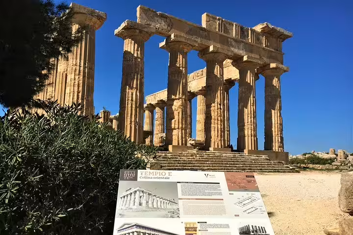 Doric temple columns and information board at the Archaeological Park of Selinunte, featured on a private tour from Palermo