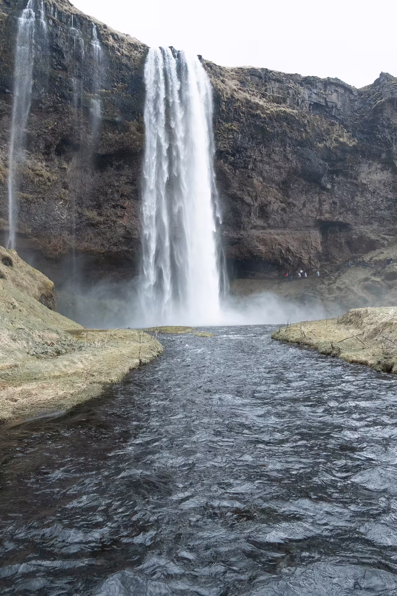 Seljalandsfoss waterfall cascading into a river on Iceland's South Coast