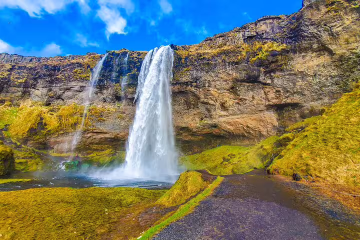 Majestic Seljalandsfoss waterfall cascading into green valley on private South Coast Iceland day tour