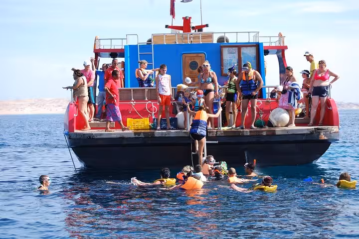 Travelers gearing up to snorkel from semi-submarine boat in Hurghada, Red Sea reef excursion