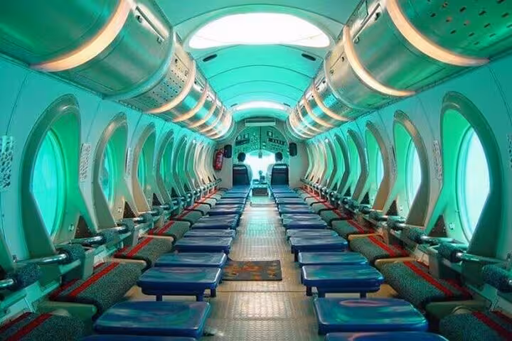 Interior of a semi submarine with panoramic underwater viewing windows and seats for a glass-bottom sea tour