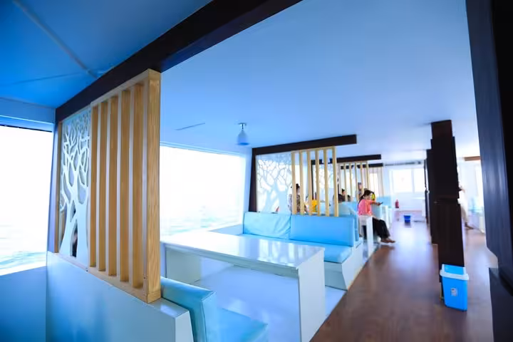 Bright semi-submersible boat lounge in Hurghada with panoramic Red Sea windows before reef viewing tour