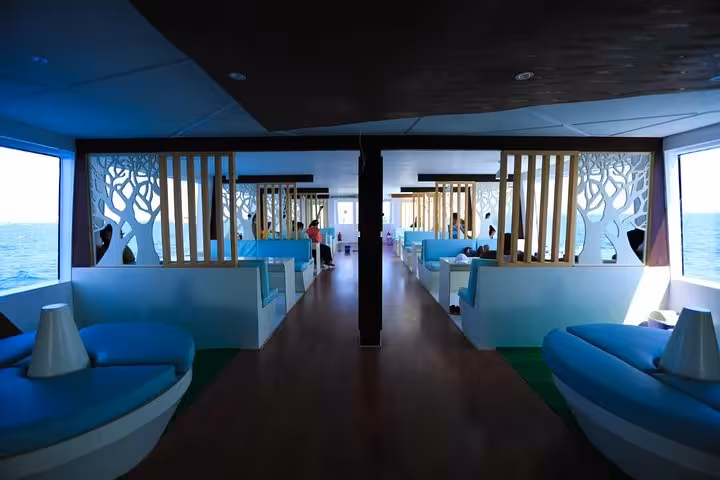 Modern semi-submersible cabin in Hurghada with panoramic sea windows and lounge seating for Red Sea reef tours
