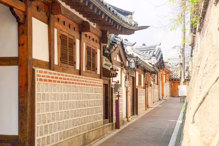 Narrow alley lined with traditional Korean hanok buildings in Seoul's historic neighborhood