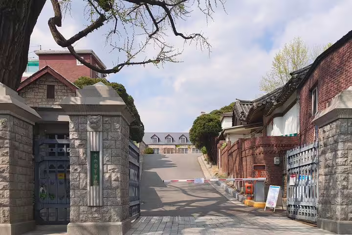 Historic Seoul gate entrance with traditional Korean architecture and stone walls on a walking tour route