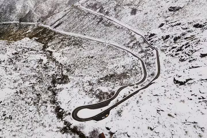 Aerial view of winding snowy roads in Serra da Estrela, ideal for adventurous private tours from Lisbon.