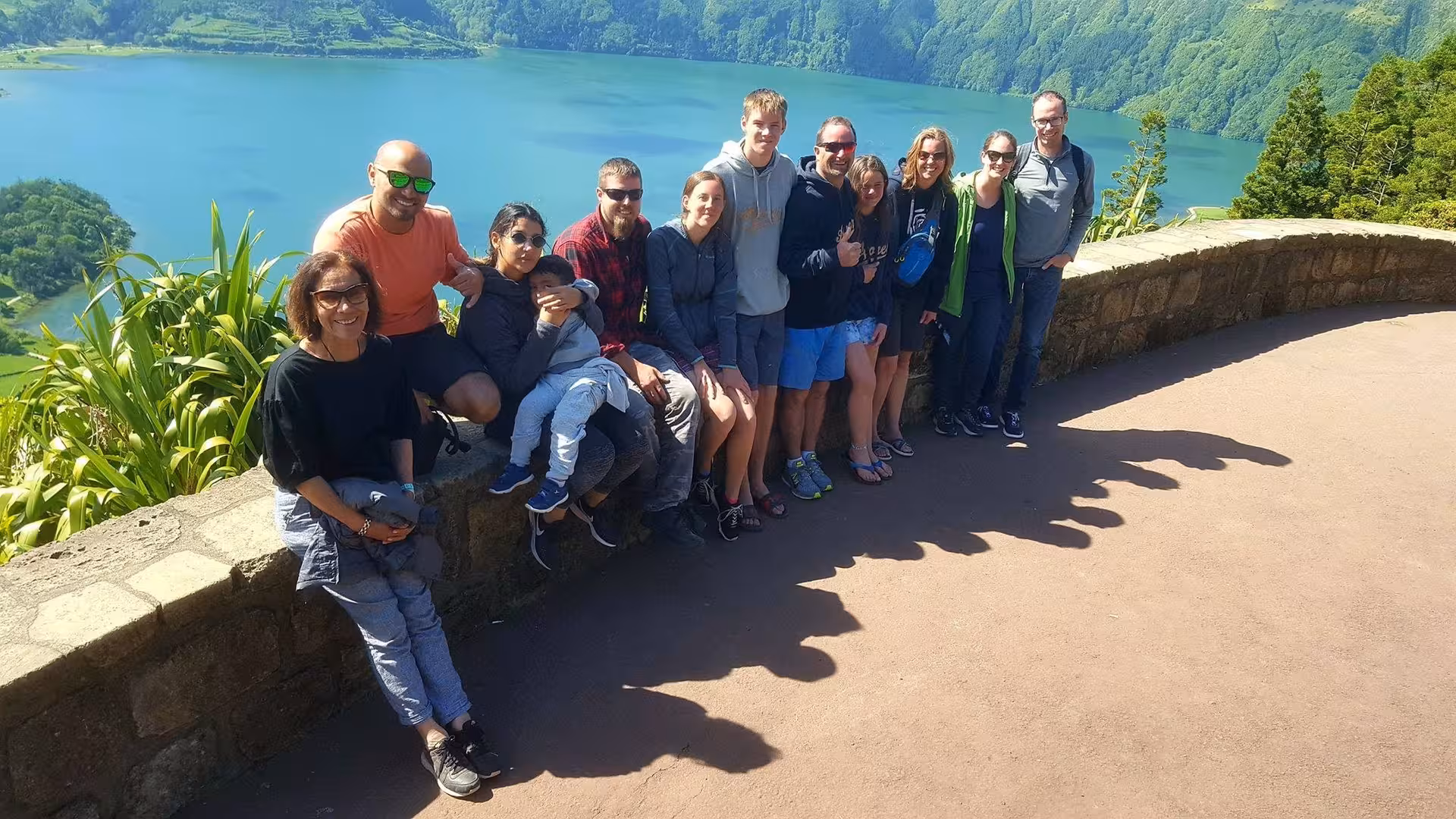 Group of tourists at a scenic Sete Cidades viewpoint overlooking the twin crater lakes on a full-day Azores van tour