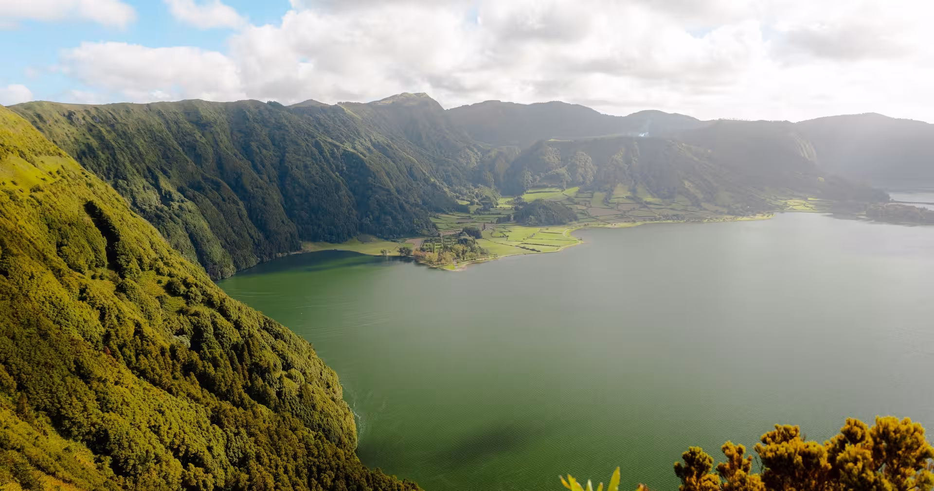Panoramic view over Sete Cidades twin lakes and green crater hills on a half-day buggy tour in São Miguel