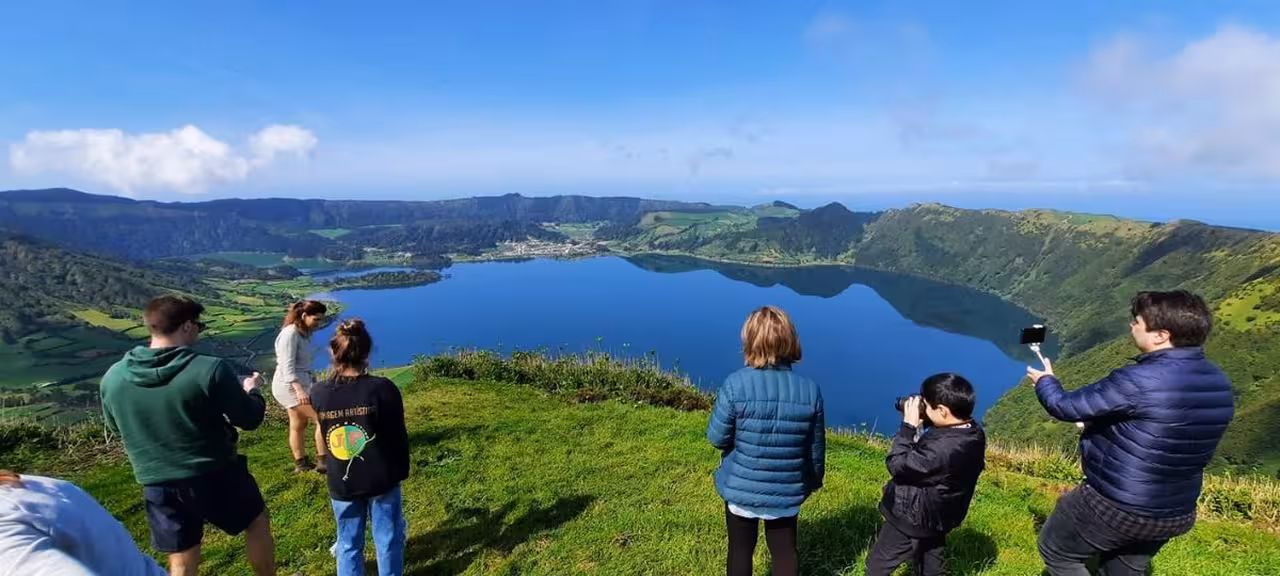 Travelers enjoying Sete Cidades crater lake viewpoint in São Miguel during a Seven Cities half-day van tour in Azores