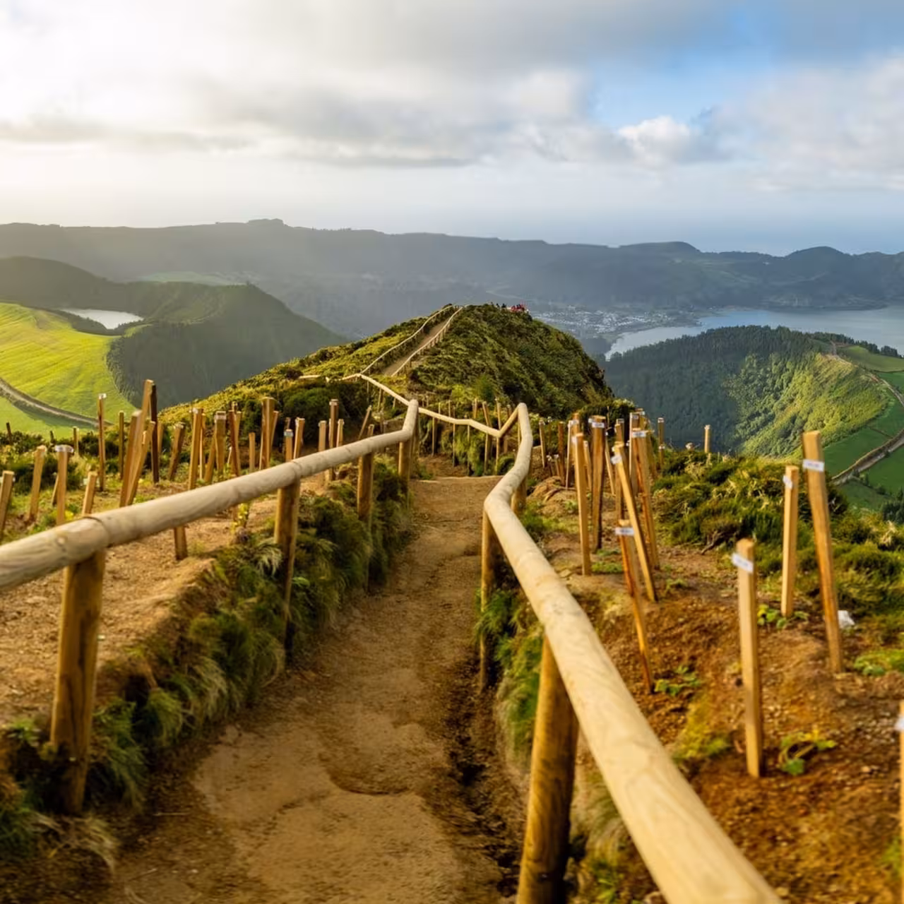 Scenic ridge trail with wooden rails overlooking Sete Cidades lakes on full-day Seven Cities walking tour with lunch
