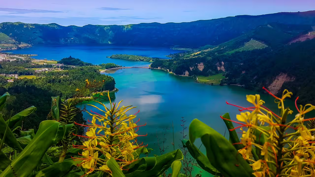 Breathtaking view of Sete Cidades twin lakes on São Miguel Island, Azores, surrounded by lush greenery and vibrant flowers.