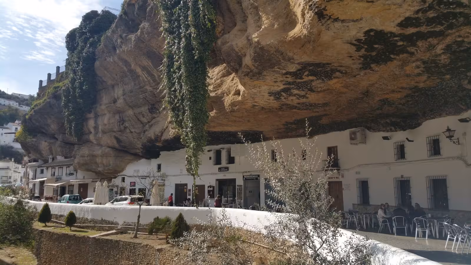 Unique cave houses with rock overhangs in Setenil de las Bodegas, showcasing its distinctive architecture.