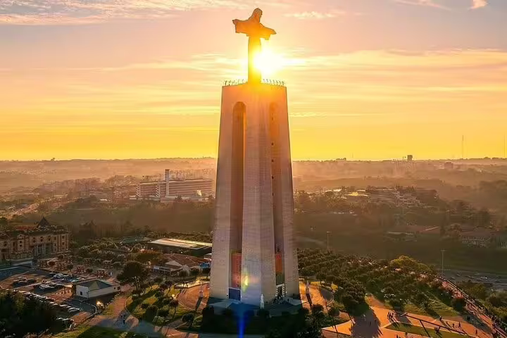 Sunset illuminating a towering monument with panoramic views of Setúbal’s historic and cultural landscape.