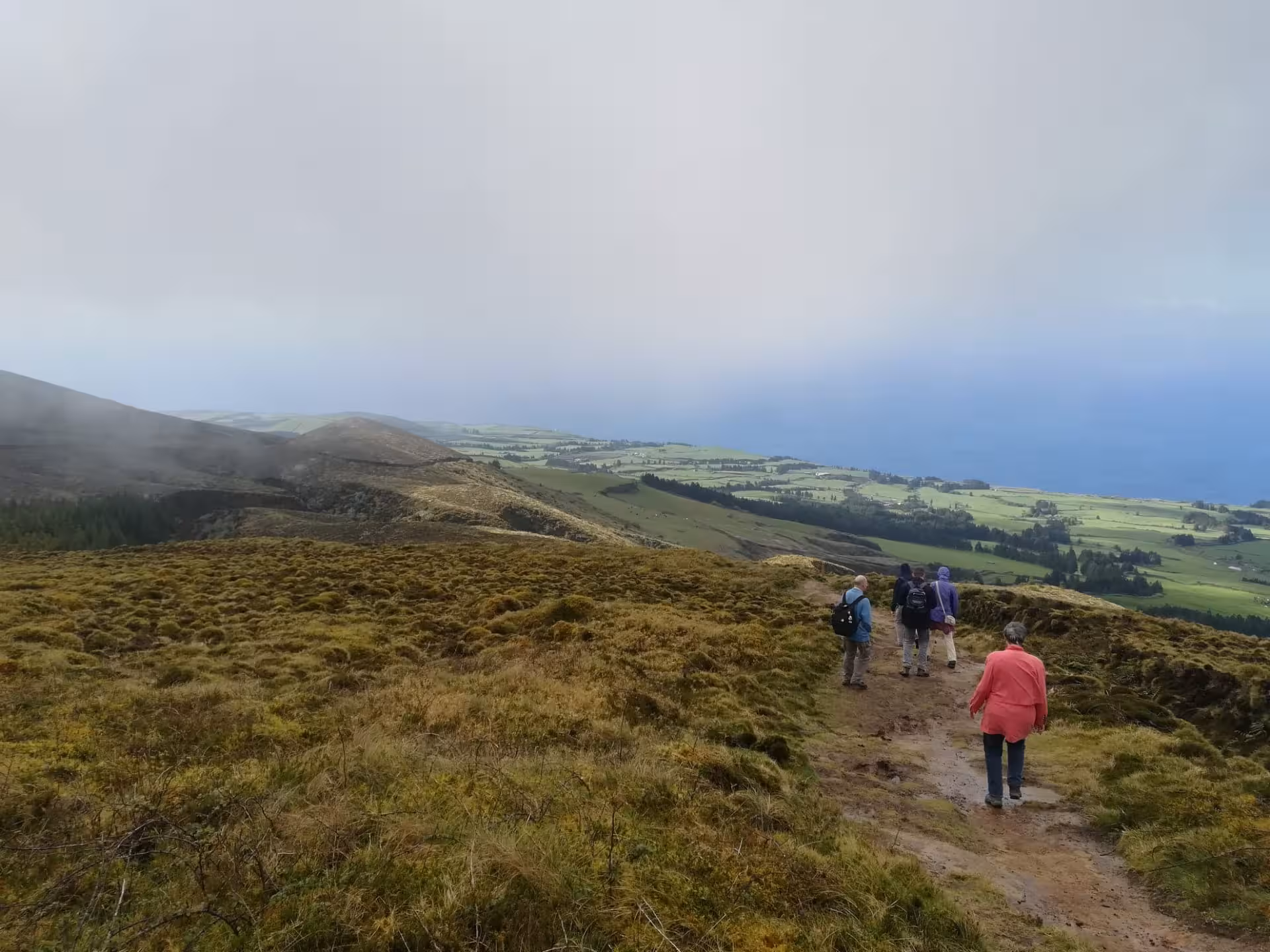 Group hiking a ridge path with ocean views on the Seven Cities half-day walking tour, Sete Cidades Azores