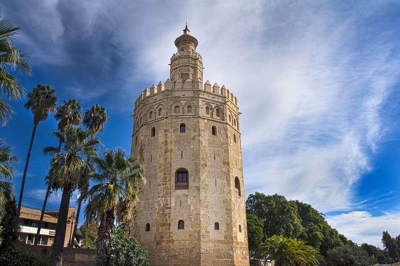 Discover the iconic Torre del Oro against a dramatic sky on a Sevilla day trip.