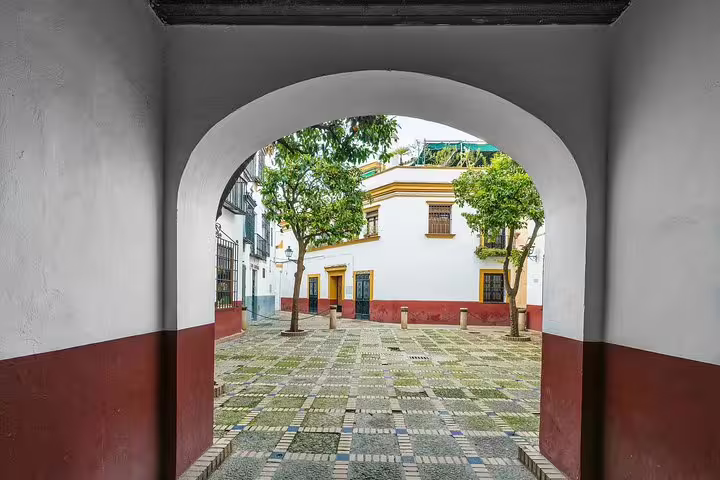 Charming courtyard view in Seville, showcasing historic architecture, included in Alcazar skip-the-line tour from Cadiz port for cruisers.