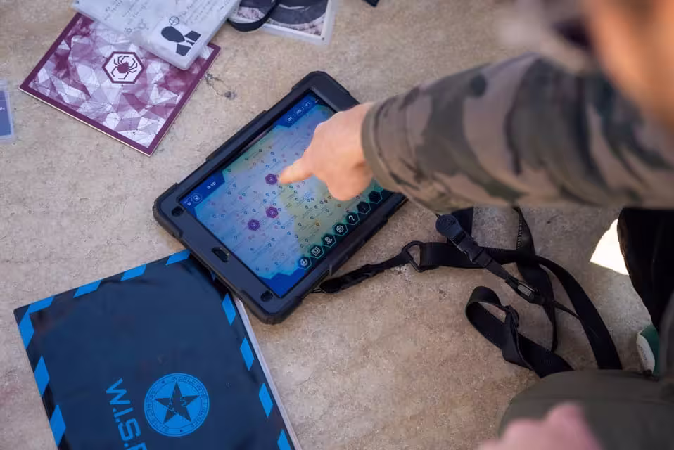 Player interacts with a tablet map to solve puzzles in Seville's challenging BlackOut escape game.