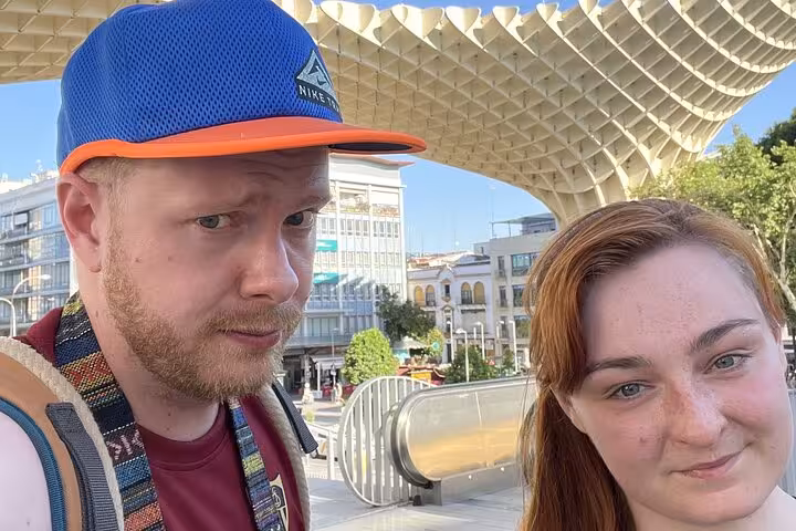 Two tourists taking a selfie at Seville's Metropol Parasol during a self-guided city tour