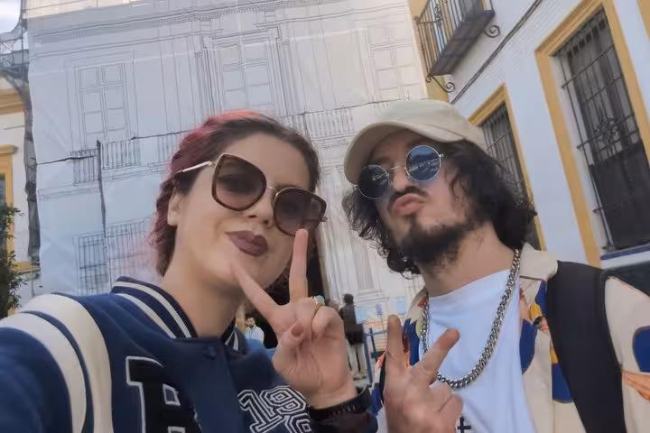 Two tourists making peace signs on a self-guided city tour in Seville, Spain