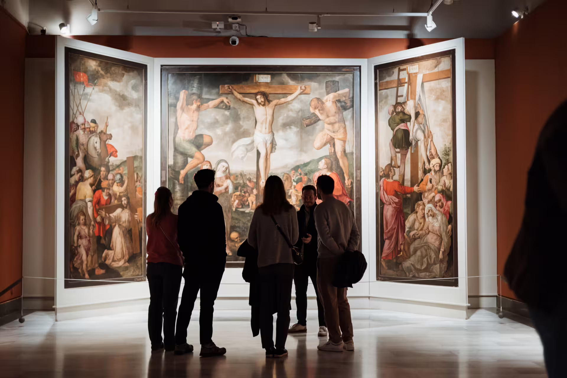 Visitors admire religious paintings at Seville's Fine Arts Museum, highlighting cultural and artistic heritage on the guided tour.
