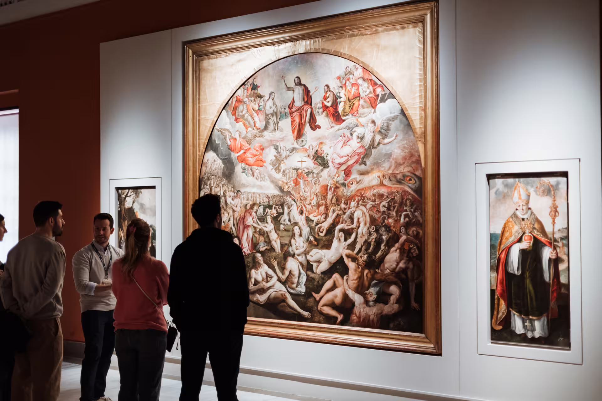 Visitors admire a masterpiece at Seville's Fine Arts Museum, showcasing Renaissance art on a guided cultural tour.