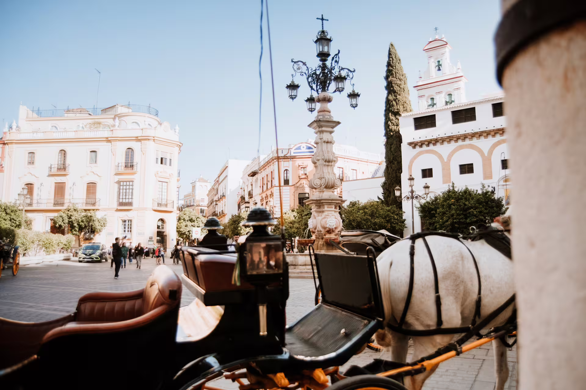 Horse-drawn carriage in Seville's historic square, capturing the charm of a private food tour through Andalusian streets.
