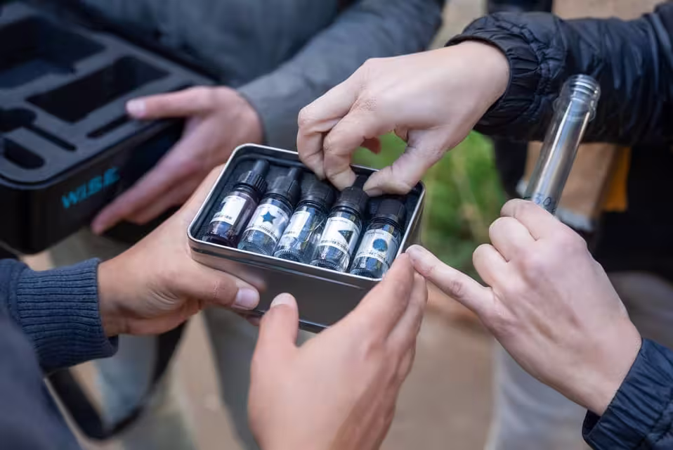 Participants examine vials during Seville's outdoor escape game, Operation Mindfall, enhancing their adventure experience.