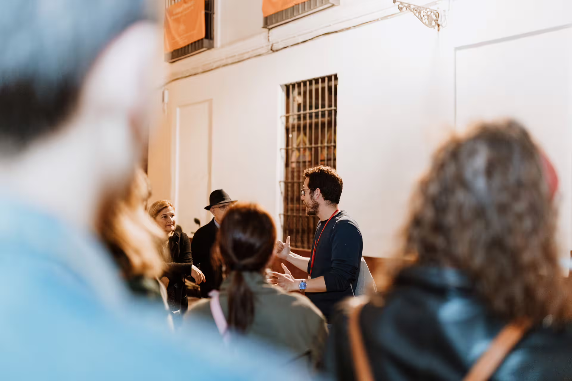 Guide leads a group through Seville's historic streets on a mysterious and paranormal tour, engaging visitors with captivating stories.