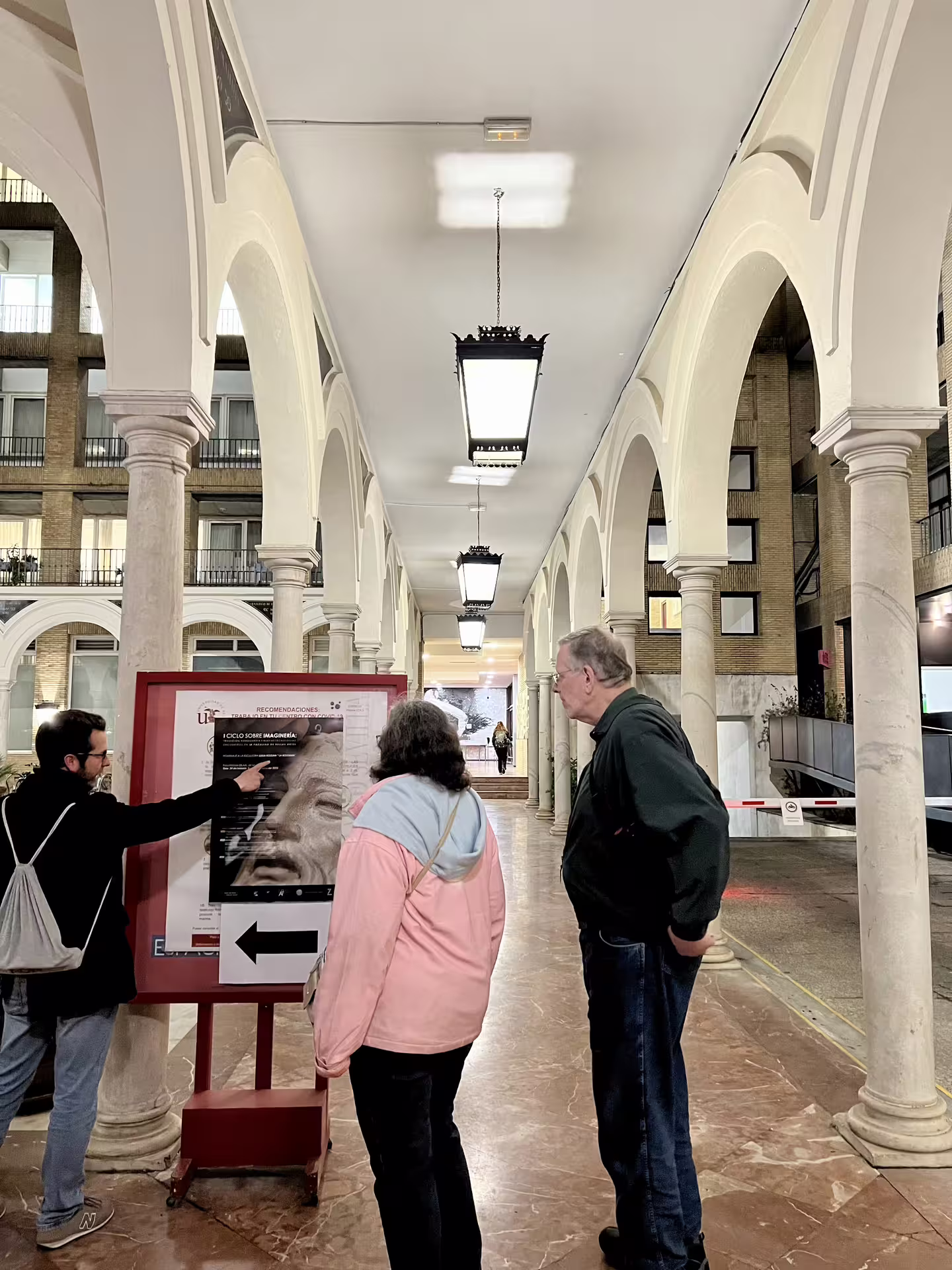 Visitors exploring historical arches during the Seville Mysterious and Paranormal Tour, highlighting local legends and lore.