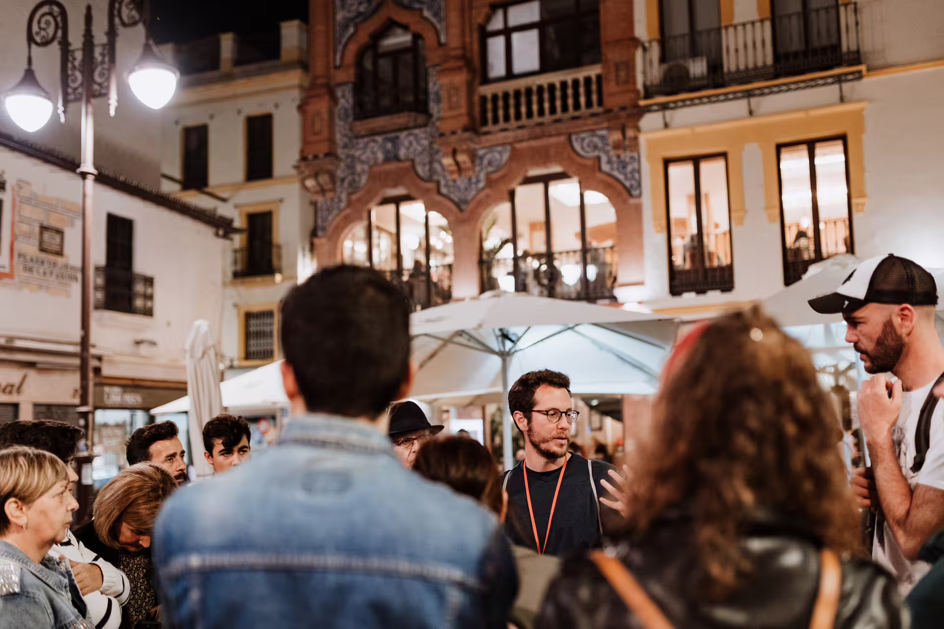 Nighttime group gathered in Seville's historic plaza for a mysterious and paranormal tour exploring local legends and ghost stories.