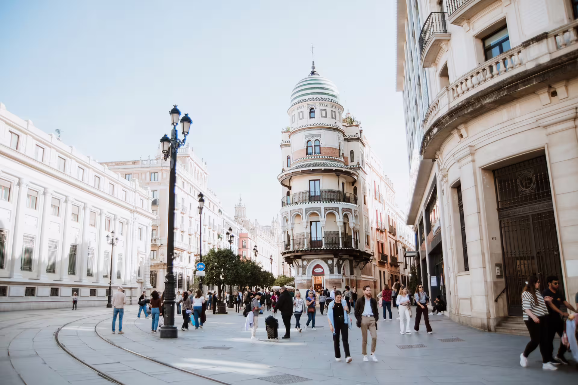 People enjoying a sunny day on Seville's historic streets, featuring unique Moorish architecture, during a small group walking tour.
